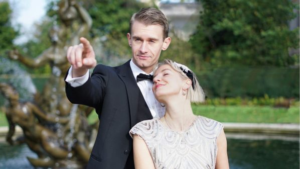 Man in a tuxedo and woman in 1920's flapper dress