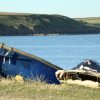 Two boats resting on the shore next to the sea on a sunny day. Location pictured is Dale, Pembrokeshire