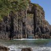 Limestone arch with almost perfect rectangular gap through the middle of it. Location is Church Doors, Pembrokeshire