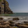 Limestone arch with almost perfect rectangular gap through the middle of it. Location is Church Doors, Pembrokeshire