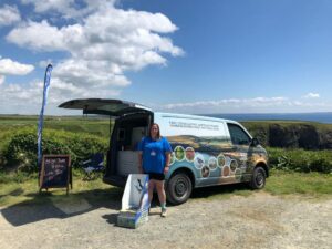 Summer Ranger Angharad standing by her van.